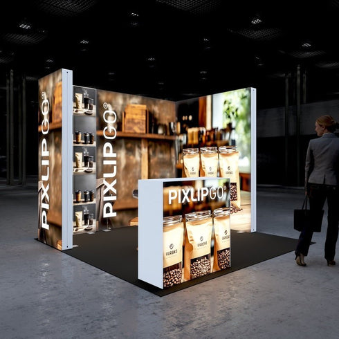A modern exhibition booth by Pixlip GO, illuminated with large lightbox walls. The booth showcases premium coffee products, such as jars of coffee beans and packaging. In the foreground, there is a lit counter featuring product images. The background displays a cozy, rustic design with wooden shelves and decor.
