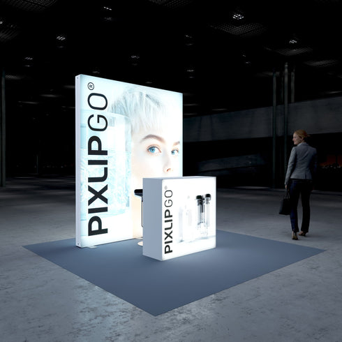 A side view of the Pixlip GO booth, showcasing the bright, clean aesthetic with its large illuminated portrait and minimalistic counter. The setup has a futuristic and polished look, with a person standing nearby and observing the booth.