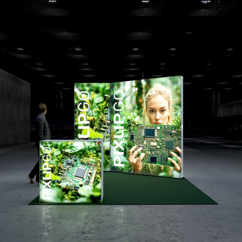 A frontal view of the Pixlip GO booth, showcasing its nature and technology fusion theme. The large illuminated backdrop features a woman holding a circuit board against a forest background. The smaller counter panels display similar eco-tech imagery. A person stands nearby.