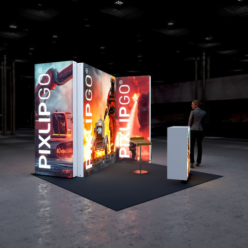 A side view of the Pixlip GO booth, emphasizing its vivid and action-packed theme. The illuminated panels display firefighting equipment, a firefighter in flames, and a robotic fire vehicle. A counter complements the scene with additional firefighting imagery, and a visitor observes from a distance.