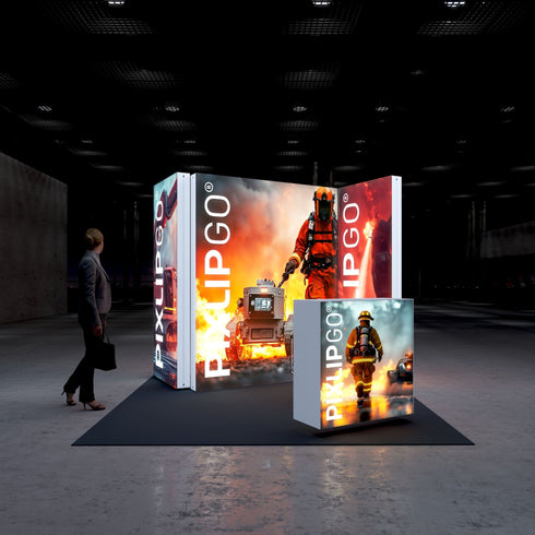 A frontal view of the Pixlip GO booth, highlighting its intense firefighting theme. The central panel displays a firefighter leading a robotic fire suppression vehicle through flames, while the smaller counter features a firefighter walking through smoke. A visitor stands nearby, engaging with the vibrant visuals.