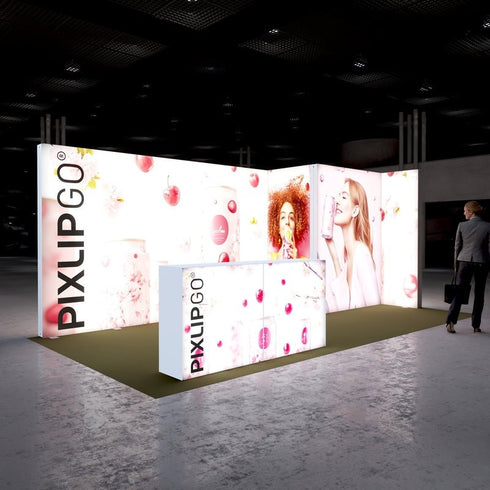 A side perspective of the Pixlip GO booth emphasizing its vibrant and cheerful design. The illuminated panels display cherry-themed drinks and smiling individuals enjoying beverages, creating an engaging and energetic atmosphere. A person observes the booth from the side.