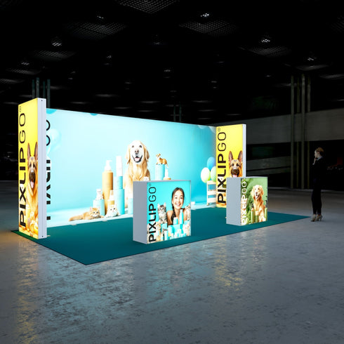 A side perspective of the Pixlip GO booth, emphasizing the bright and colorful theme. The display includes vivid images of pets, balloons, and care products, with counters adding visual interest with smiling pet owners and product images. A visitor walks by, intrigued by the display.