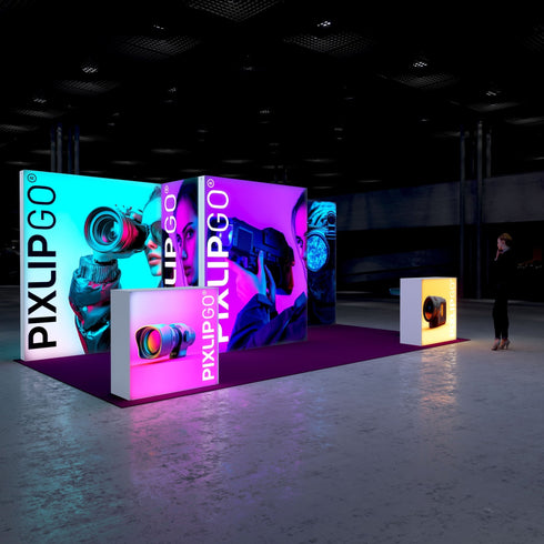 A side perspective of the exhibition setup, presenting a sleek design with glowing displays featuring high-tech camera imagery. The layout includes a magenta floor, lit display cubes, and a sophisticated environment emphasizing cutting-edge technology.