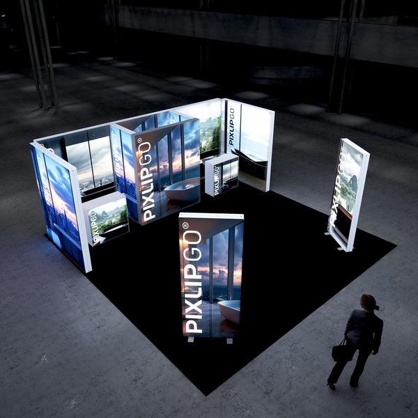 A modern exhibition booth with PIXLIP GO illuminated panels displaying scenic views through large windows, featuring a luxurious bathtub in a serene setting. The display is set up on a black floor, creating a sophisticated ambiance.