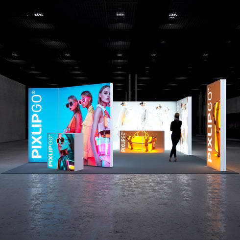 Front view of an exhibition stand with colorful illuminated displays. Models with trendy sunglasses and stylish outfits dominate the central blue panels, while a glowing orange display highlights a sleek handbag. The overall design emphasizes modern fashion and bright aesthetics.