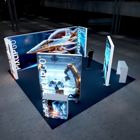 A high-tech trade show booth featuring a futuristic jet design on illuminated panels. The booth showcases robotic arms working in a manufacturing setting and interactive technological displays on the panels. A visitor is walking by, observing the setup.