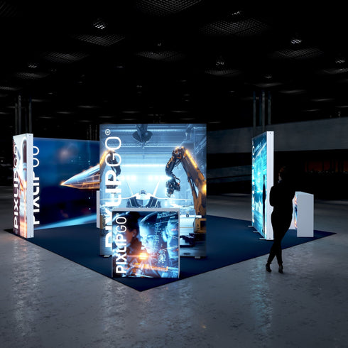 A perspective view of the booth with a focus on the robotic arm working on a jet model. The illuminated displays depict advanced aerospace technology and robotic automation. The booth's sleek and modern design stands out against the dimly lit environment.