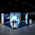A perspective view of the booth with a focus on the robotic arm working on a jet model. The illuminated displays depict advanced aerospace technology and robotic automation. The booth's sleek and modern design stands out against the dimly lit environment.