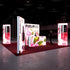 A brightly illuminated exhibition booth featuring a floral and beauty product theme. The main panel showcases a variety of pink flowers and cosmetic bottles, framed with glowing panels and the PIXLIP GO branding. A person in professional attire observes the booth.