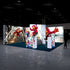 A front-facing view of a colorful trade show booth. The centerpiece features a red character skateboarding down stairs, with adjacent illuminated displays showcasing colorful skateboards and action shots, evoking a sense of movement and excitement.